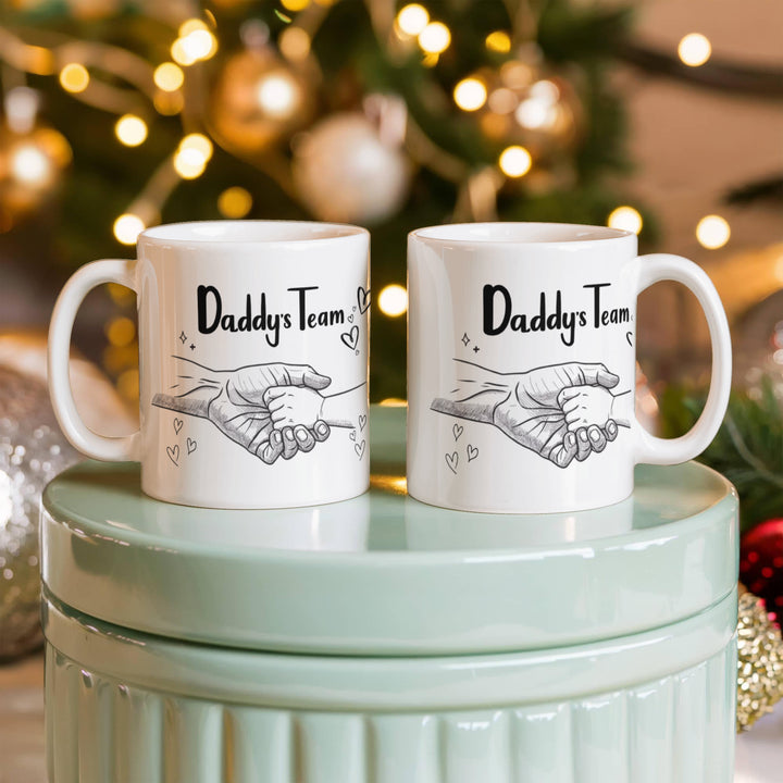 Father and baby hands on 'Daddy's Team' mug
