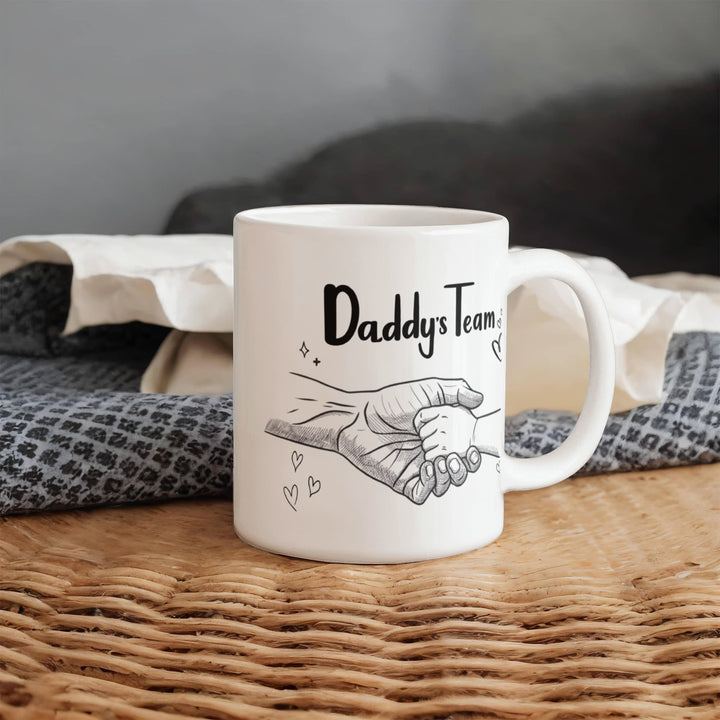"White mug showing dad and child hand in hand