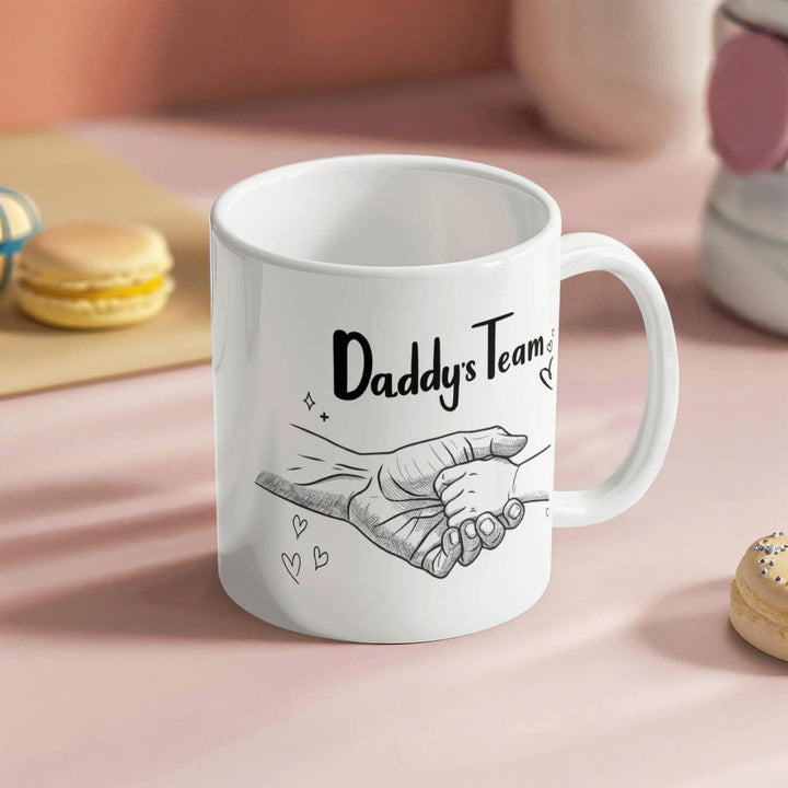 "White mug showing dad and child hand in hand