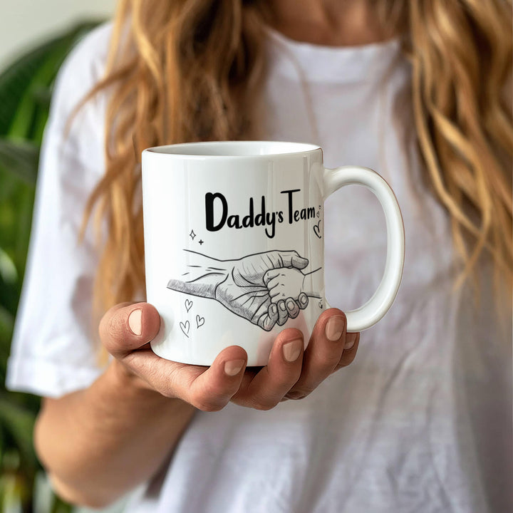 "White mug showing dad and child hand in hand