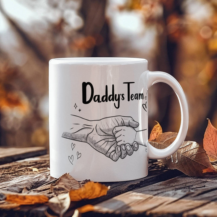 "White mug showing dad and child hand in hand